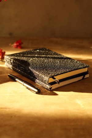 Notebook and pen on a wooden background. Selective focus.
