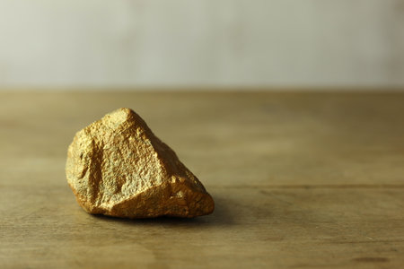 gold rock on wood backgroundの写真素材