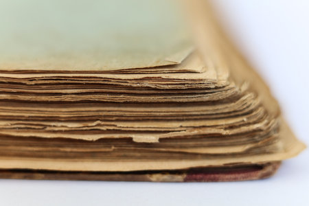 Old book on white background. Close-up. Shallow DOF.の写真素材
