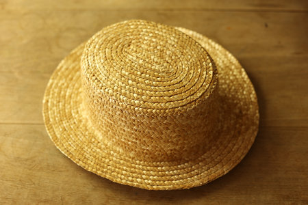 Straw hat on wooden background. Close-up of straw hat.の写真素材