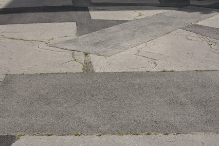 asphalt pavement with cracks and patchesの写真素材
