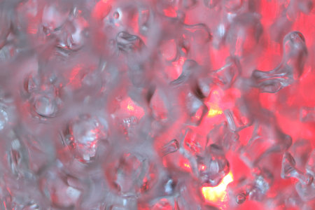 macro photo of hydrogel balls in red lightの写真素材