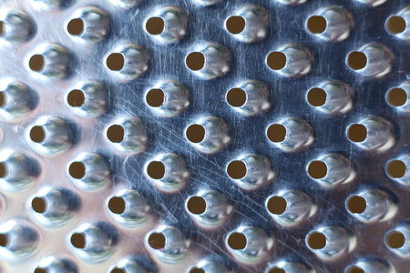 close-up of a metal grater textured backgroundの写真素材