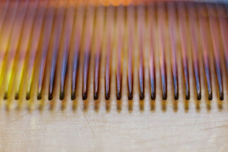 Close up of a retro comb on a wooden table. Shallow depth of field.の写真素材