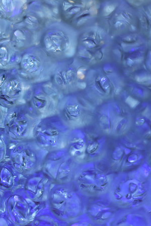 hydrogel balls in blue light abstract background, close up.の写真素材