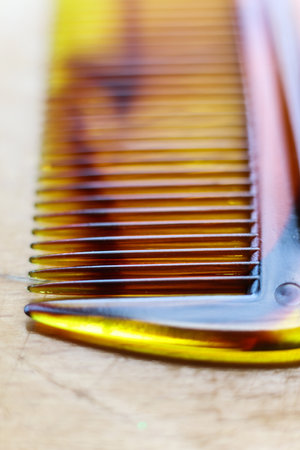 Close up of a retro comb on a wooden table. Shallow depth of field.の写真素材
