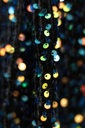 Colorful sequins on a black fabric as a background. macroの写真素材