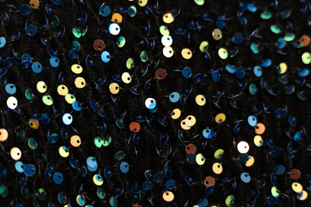 Colorful sequins on a black fabric as a background. macroの写真素材