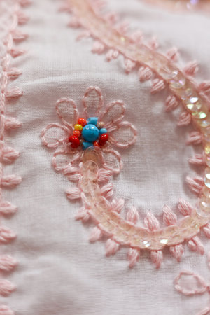 Beautiful embroidery on a pink fabric. Close-up.の写真素材