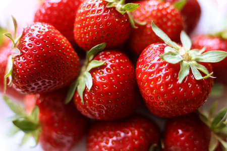 fresh strawberries with green leaves, close up photoの写真素材
