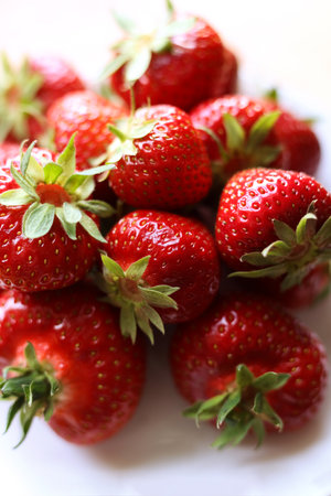 fresh strawberries with green leaves, close up photoの写真素材
