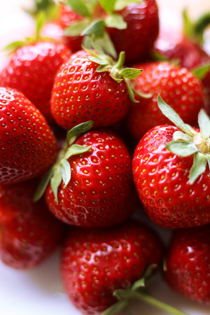 fresh strawberries with green leaves, close up photoの写真素材