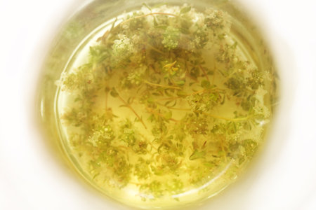 Herbal thyme tea in a glass jar, shallow depth of field.の写真素材
