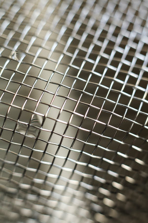 Close up of a stainless steel mesh for background or texture use.の写真素材
