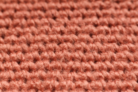 Macro detail of crochet fabric texture background.