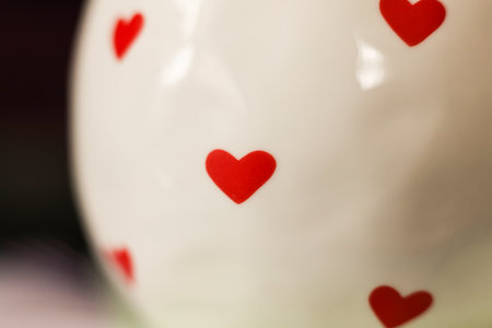 Red hearts on a white porcelain mug, shallow depth of fieldの写真素材