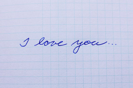 I love you written on a notepad, closeup of photo