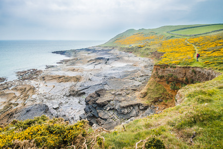 Rocky Sea Shore View On A Cloudy Day In Rhossili, Wales Coast Pathの写真素材