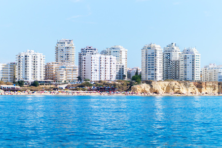 View from the sea to the apartments of Armacao de Pera and Praia do Vale do Olival beach, Algarve Portugalの写真素材
