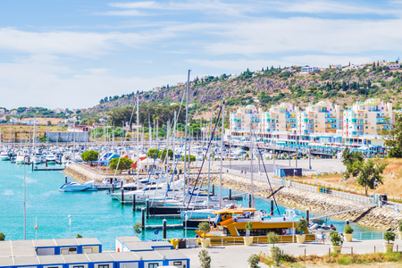 Vivid view of buildings and boats in the Porto de Abrigo de Albufeira, Albufeira Bay in Albufeira, Portugalの写真素材
