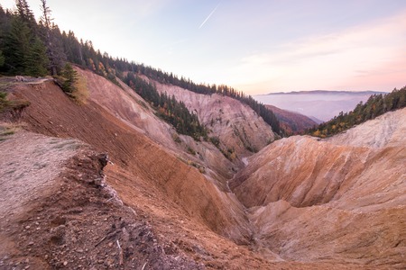 Sunset view at the Ruginoasa Hole or Groapa Ruginoasa in the south close to the Dry Valley in Apuseni Natural Park, Romania.の写真素材