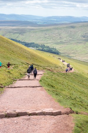 Brecon Beacons, Wales - May 05, 2017: People in distance walking on the footpath that leads to Pan Y Fan peak of Brecon Beacons in Wales..のeditorial素材