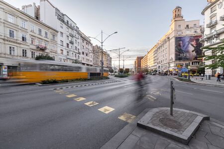Budapest, Hungary - October 04, 2019: Karoly street circle or KÃ¡roly kÃ¶rÃºt twilight street view with 49, 47 yellow vintage tram and a cyclist passing by, in Budapest eraly Autumn.のeditorial素材