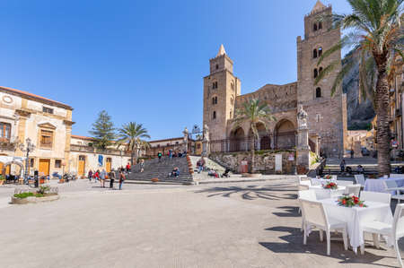 Cefalu, Italy - March 24, 2019: People walking on the street around Duomo di CefalÃ¹ in Sicily on a sunny day in spring - angled view.のeditorial素材
