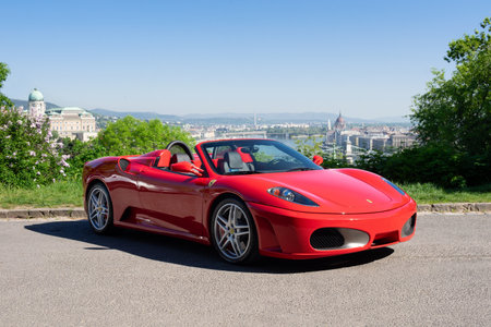 BUDAPEST, HUNGARY - May 11, 2021: Ferrari F430 - Spider, Italian sports car interior designed by Pininfarina, photographed by GellÃ©rt Hill lookout point, with the panorama of Budapest.のeditorial素材