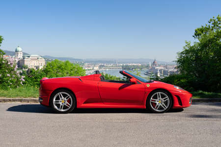 BUDAPEST, HUNGARY - May 11, 2021: Ferrari F430 - Spider, Italian sports car interior designed by Pininfarina, photographed by GellÃ©rt Hill lookout point, with the panorama of Budapest.のeditorial素材