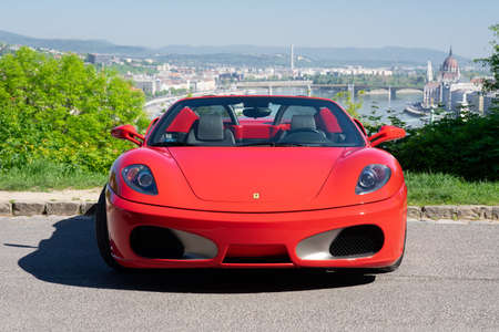 BUDAPEST, HUNGARY - May 11, 2021: Ferrari F430 - Spider, Italian sports car interior designed by Pininfarina, photographed by GellÃ©rt Hill lookout point, with the panorama of Budapest.のeditorial素材