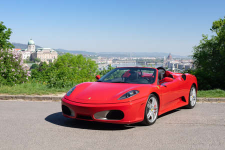 BUDAPEST, HUNGARY - May 11, 2021: Ferrari F430 - Spider, Italian sports car interior designed by Pininfarina, photographed by GellÃ©rt Hill lookout point, with the panorama of Budapest.のeditorial素材