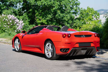 BUDAPEST, HUNGARY - May 11, 2021: Ferrari F430 - Spider, Italian sports car interior designed by Pininfarina, photographed by GellÃ©rt Hill lookout point, with the panorama of Budapest.のeditorial素材