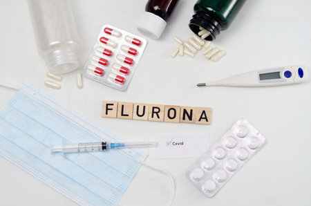The word FLUORIA is written in wooden letters on a background of medical items.の写真素材