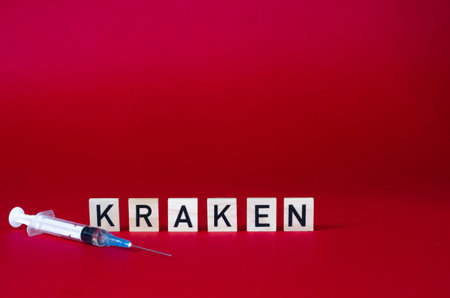 Syringe and wooden cubes with the word KRAKEN on red backgroundの写真素材