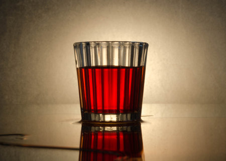 Glass of red wine on a wooden table. Selective focus. Toned.の写真素材
