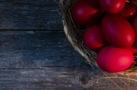 Easter eggs in a basket on a wooden background. Top view.の写真素材