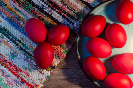 Easter eggs in a plate on a wooden background. Selective focus.の写真素材