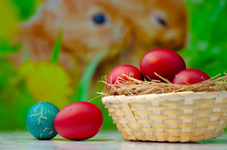 Easter eggs in a basket on a green background. Selective focusの写真素材