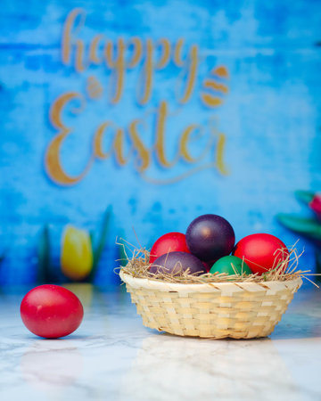 Easter eggs in a basket on a blue background. Happy Easterの写真素材