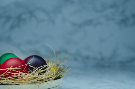 Easter eggs in a bowl on a marble background with copy spaceの写真素材