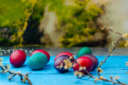 Easter eggs painted in red and blue colors on a wooden backgroundの写真素材