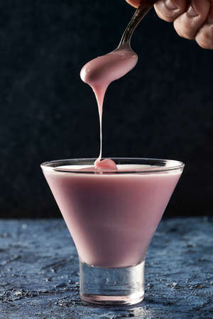 eating strawberry yogurt in a glassの写真素材