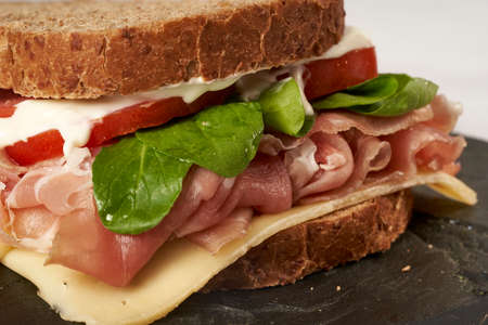 close up Serrano ham prosciutto cheese, arugula, tomato and mayonnaise sandwichの写真素材