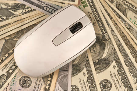 computer mouse over different dollar billsの写真素材