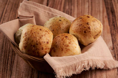 basket with salami and cheese flavored breads