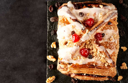 top view apple strudel with walnuts, raisins and jellied cherries