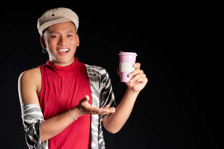 latin man showing his coffee mugの写真素材