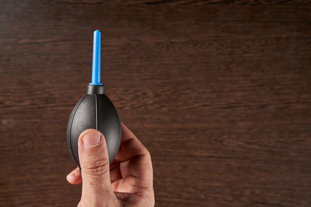 hand holding an air blower for cleaningの写真素材