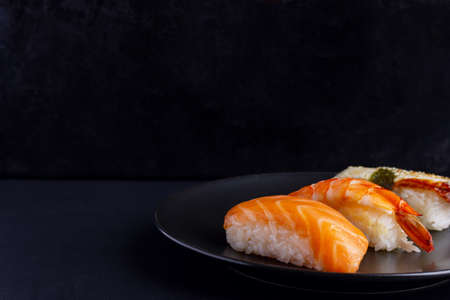 Nigiri sushi set on black background, traditional Japanese foodの写真素材